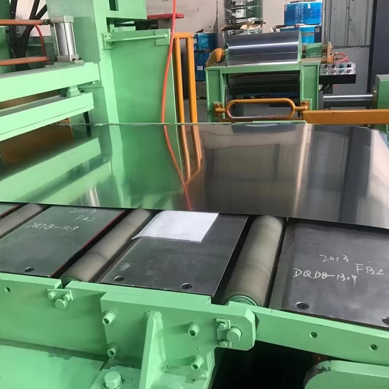 CNC laser cutting machine sizing an ASTM A240 304 stainless steel plate to custom engineering blueprints CNC laser cutting machine sizing an ASTM A240 304 stainless steel plate to custom engineering blueprints